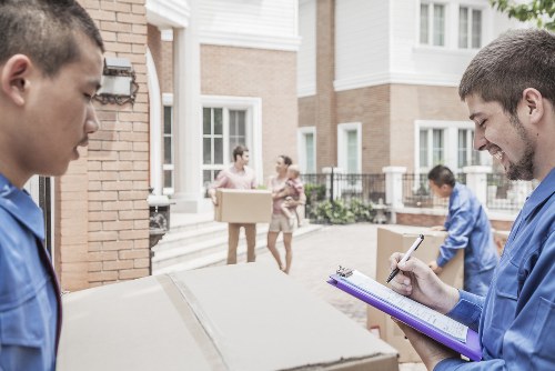 Professional movers handling boxes during a Bayswater flat relocation