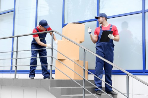 Bayswater moving service with van and helper unloading furniture